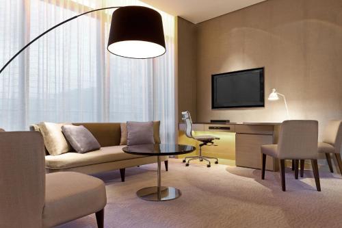 a living room with a couch and a table at Le Meridien Taipei in Taipei