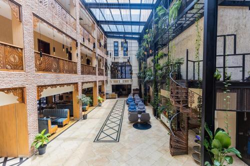 an indoor greenhouse with potted plants in a building at Mukhrantubani Boutique Hotel in Tbilisi City