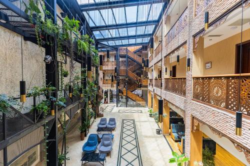 an empty hallway with benches and plants in a building at Mukhrantubani Boutique Hotel in Tbilisi City
