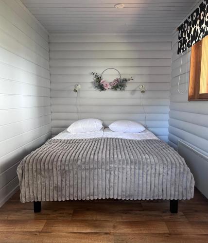 a bed with two pillows in a room at Jauri Resort in Kemijärvi