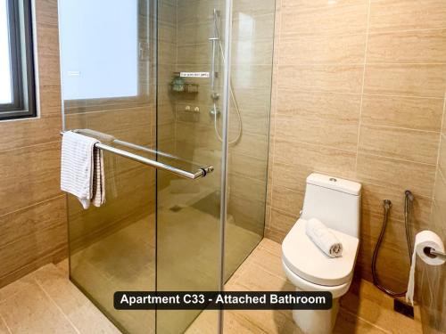 a shower stall in a bathroom with a toilet at By the Sea- Pool and Sea View in Batu Ferringhi