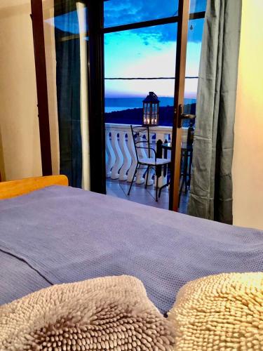 a bedroom with a bed and a view of a balcony at Apartment Aida in Karlobag
