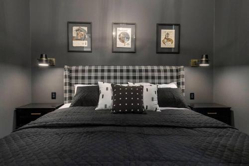 a bedroom with a bed with four pictures on the wall at Downtown Derby Delight in Louisville