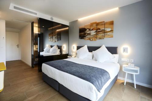a hotel room with a large bed and a bedroom at Sercotel Valencia Alameda 41 in Valencia