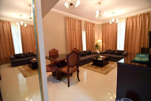 a living room with a couch and a table at Emirates Stars Hotel Apartments Sharjah in Sharjah