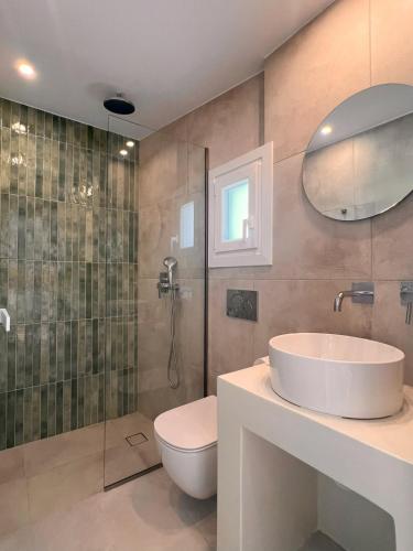 a bathroom with a toilet and a sink and a shower at Acropolis in Parikia