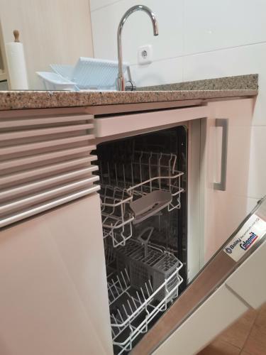 a kitchen with an oven with a dish rack in it at Apartamento centrico en Calella in Calella