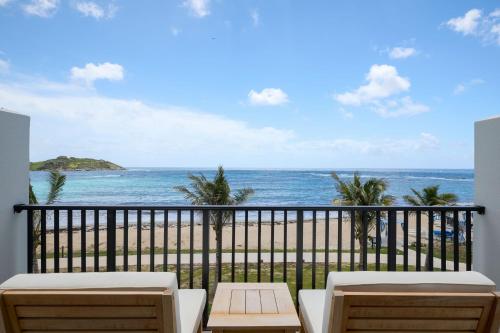a balcony with a view of the ocean at JW Marriott St Maarten Beach Resort & Spa in Dawn Beach