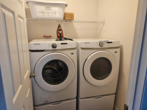 a laundry room with a washer and dryer at Mufasa's Pride in Kissimmee