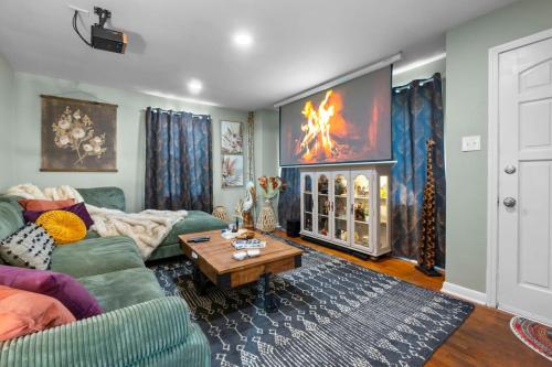 a living room with a couch and a table at SEMO Redhawks Campus Home with Hot Tub in Cape Girardeau