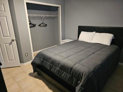 a bedroom with a bed and a closet with hangers at Mufasa's Pride in Kissimmee
