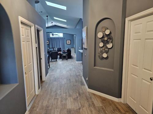 a hallway with blue walls and a white door at Mufasa's Pride in Kissimmee