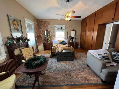 a living room with a bed and a couch at The Mediterranean House - Beautiful Downtown House in Perryville