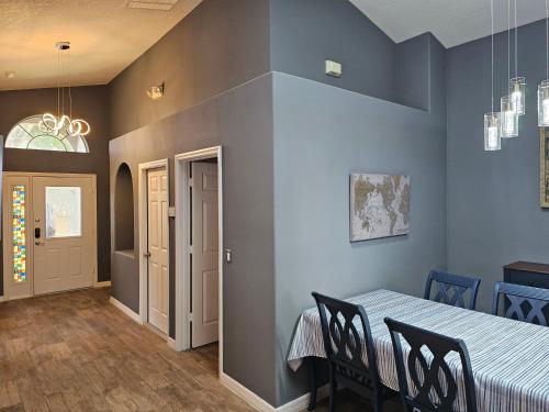 a dining room with a table and chairs at Mufasa's Pride in Kissimmee