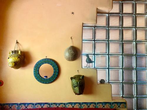 a wall with some vases and masks on it at Lakefront bungalow - Relaxation Plus in Santa Cruz La Laguna