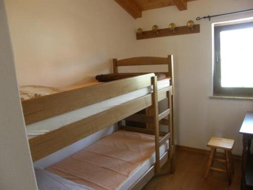 two bunk beds in a room with a window at Apartman Iris in Gabonjin