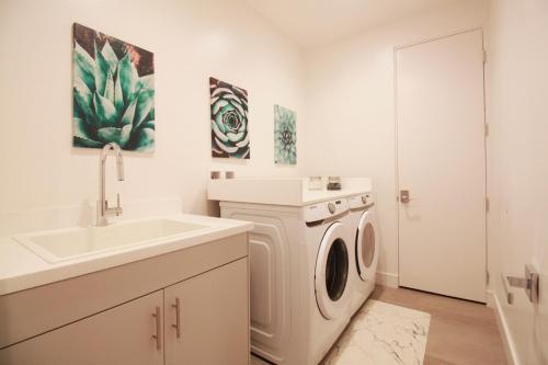 a white laundry room with a sink and a washing machine at Best Spot in Indian Wells. Walk to Tennis Gardens in Indian Wells