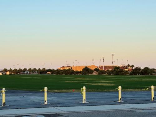 a group of yellow poles in a parking lot at Best Spot in Indian Wells. Walk to Tennis Gardens in Indian Wells