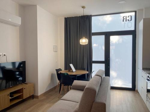 a living room with a couch and a table at Dormavalencia Crónica in Valencia