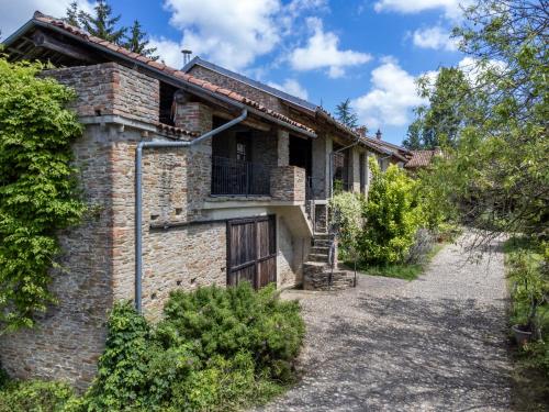 an old brick house with a gate and a driveway at Holiday Home Borgo del Riondino by Interhome in Trezzo Tinella