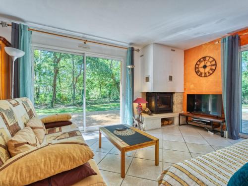 a living room with a couch and a table at Holiday Home Tina by Interhome in Naujac-sur-Mer