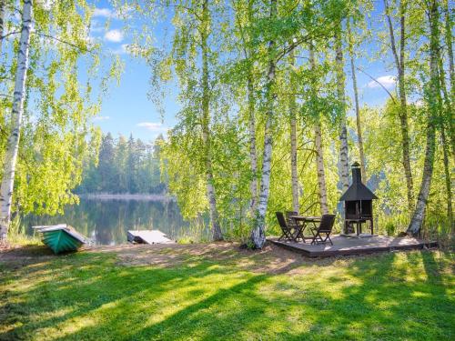 un tavolo da picnic e una griglia accanto a un lago di Holiday Home Kaisla by Interhome a Torvoila