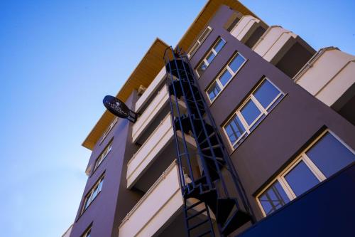 a tall building with a fire escape on it at Miss Cleopatra Hotel in Alanya