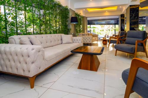 a living room with a couch and a table at Miss Cleopatra Hotel in Alanya