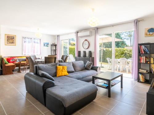 a living room with a couch and a table at Holiday Home Carraou by Interhome in Vielle-Saint-Girons
