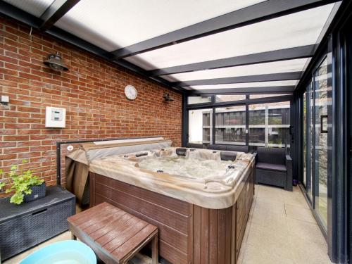 a hot tub in a room with a brick wall at Holiday Home Neurazy by Interhome in Neurazy