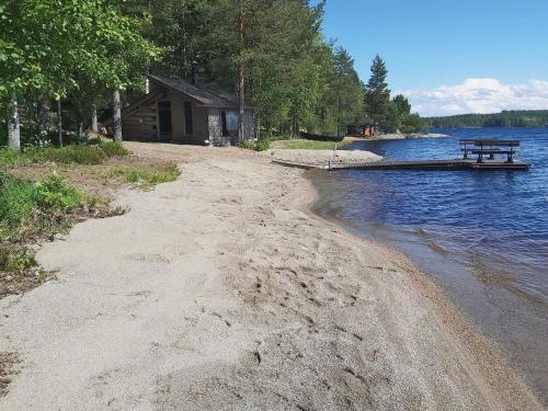 a picnic table on the shore of a lake at Holiday Home Kokkoranta by Interhome in Ilomantsi