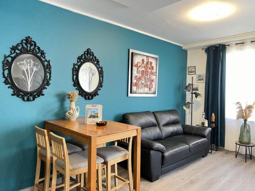 un salon avec une table et un canapé dans l'établissement Le Solena, à Calais
