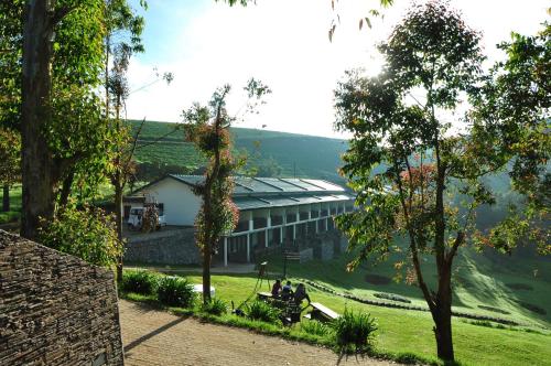 two people sitting on a bench in front of a building at Destiny - The Farm Resort in Ooty
