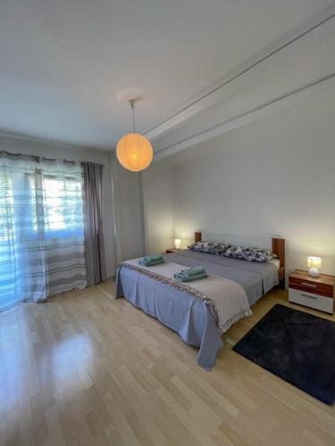 a bedroom with two beds and a chandelier at Villa Ska in Pula