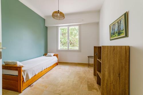 une chambre avec un lit et une fenêtre dans l'établissement Haut de villa, vue sur mer à Sainte-Maxime, à Sainte-Maxime