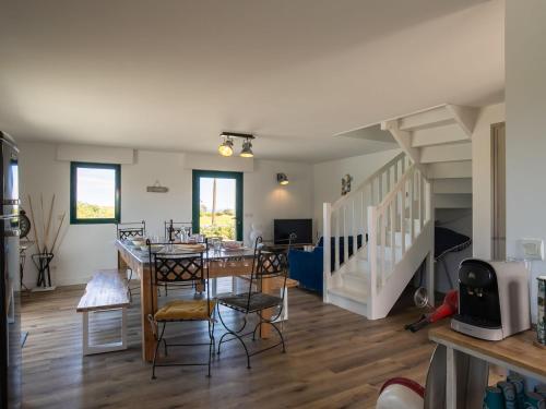 un salon avec une table et des chaises et un escalier dans l'établissement Holiday Home Ty Man by Interhome, à Guimaëc