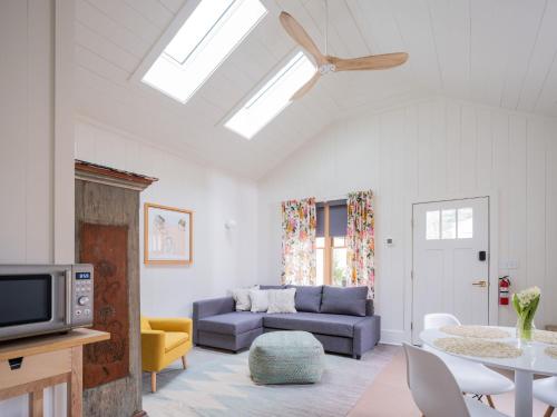 a living room with a couch and a table at Queen City Bungalow & Cottages in Burlington