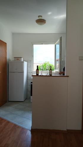 a kitchen with a counter with two wine glasses at Macy 25 in Kotor