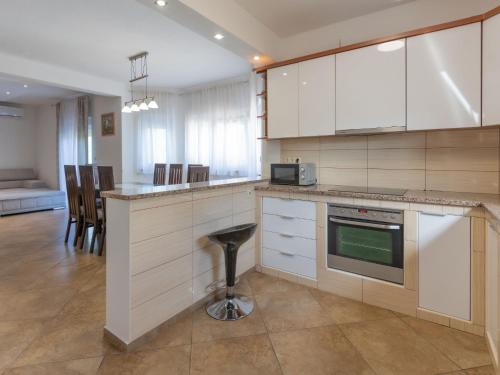 a kitchen with white cabinets and a counter top at Holiday Home Villa Dalmatina by Interhome in Imotski