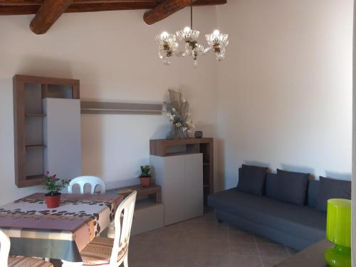 a living room with a table and a blue couch at Mary's House in Guardistallo