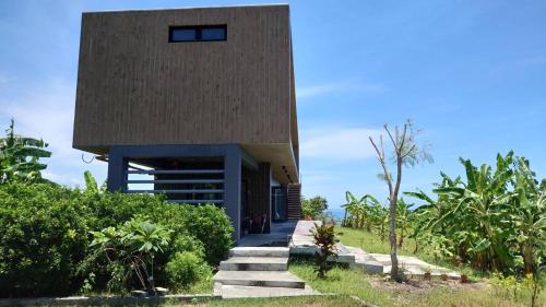 a house on a hill with a building at 山海高台民宿 M&S nature view house in Chenggong