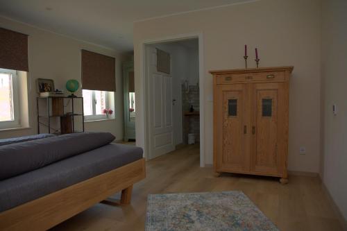 a living room with a couch and a wooden cabinet at Landlust Unser L ieblingscafe in Xanten