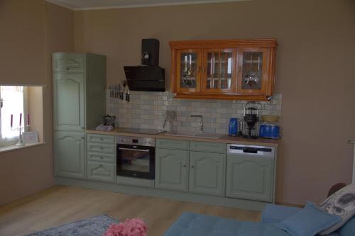 a kitchen with white cabinets and a counter top at Landlust Unser L ieblingscafe in Xanten