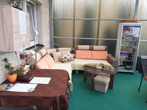 a living room with a couch and a table at Apartmán LUKA in Buchlovice