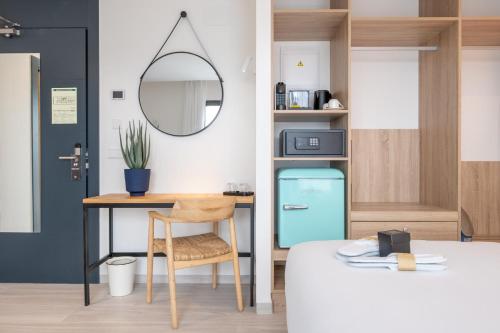 a room with a table and a blue refrigerator at Hotel Cetina Cabo de Palos Puerto in Cabo de Palos