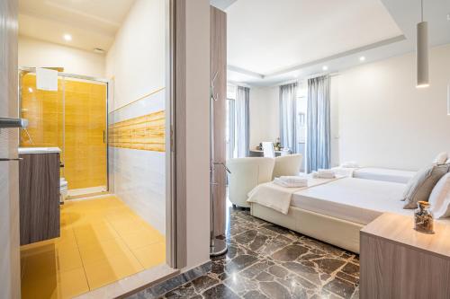 a bedroom with a bed and a bathroom with a shower at Dei del Mare Extra Luxury in Gallipoli