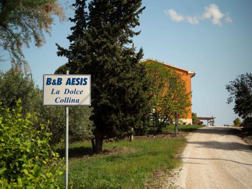 a sign sitting on the side of a road at B&B Aesis La Dolce Collina in Iesi