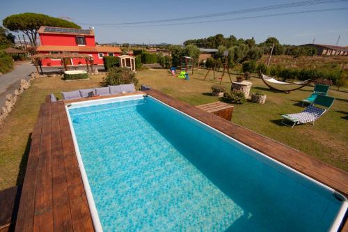 a large swimming pool in a yard next to a house at Agriturismo L'Istrice di Giò in Montalto di Castro