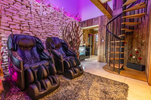 two empty chairs in a room with a brick wall at Quob Park Old House Hotel & Spa in Fareham