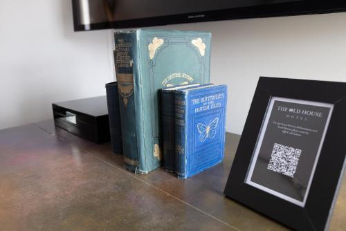 a group of books sitting on a table next to a plaque at Quob Park Old House Hotel & Spa in Fareham